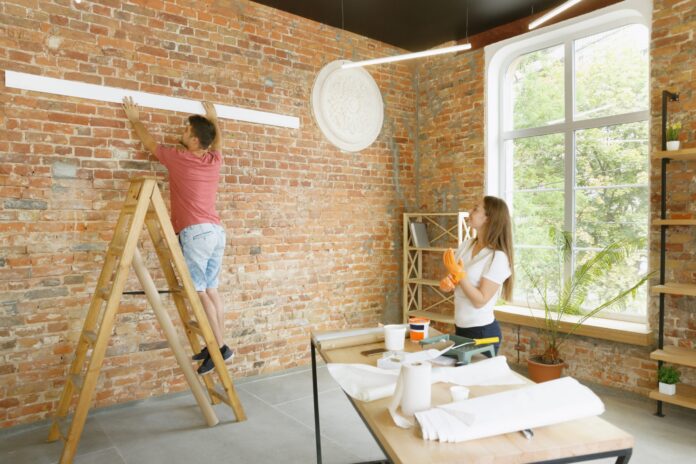 young-couple-doing-apartment-repair-together-themselves-married-man-woman-doing-home-makeover-renovation-scaled